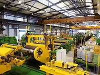 Uncoiling section, edge trimming, slitting and tension leveling line