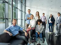 Male apprentice in front of industrial plant
