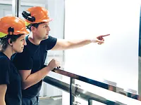 2 people with orange helmets