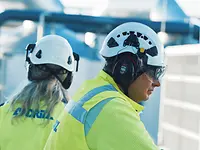 Pulp mill aerial overview drone image, with the mill in the foreground and open grasslands in the background.