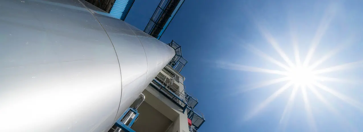 A view looking straight up from the base of A-ConApex reactor, with the sun on the right.
